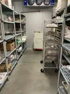Cold storage shelving and rolling racks inside Five Star Food Stop