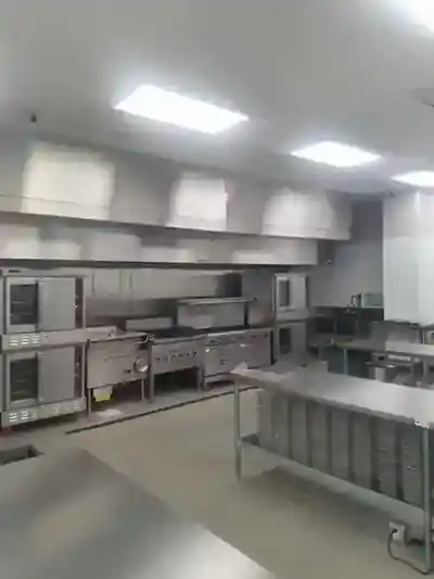 Commercial cooking line with ovens, ranges and ventilation hood inside Five Star Food Stop